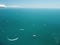 Aerial yacht on calm sea. Luxury cruise trip. View from above of white boat on deep blue water. Aerial view of rich