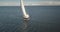 Aerial of yacht under sails. Sailboat reflect at open sea. Racing yacht seascape. Luxury sail boat