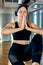 Aerial yoga A beautiful girl aerial yoga trainer shows a variety of exercises on hanging lines in a yoga room. Concept