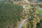 Aerial zenith view with drone  of a mountain road through oak forests. Enjoy driving concept