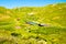 Aerial zoom out view Shuamta small lake surrounded by mountain village wooden houses in high Adjara