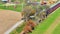 Aerial Zoomed in View of an Approaching Steam Passenger Train on a Single Track in the Countryside