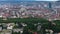 Aerial zoomed view of urban neighbourhood with parks and greenery. Several modern high rise buildings in distance