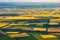 Aeriall view of patchwork of  yellow and green fields.