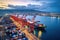 Aerical view of a busy seaport with cargo ships being loaded and unloaded.