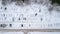 Aerila view of snow-covered cars stand in the parking lot on a winter day