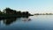 Aero. group of women practicing SUP yoga, they balancing on paddle boards, on water of large river, during summer warm