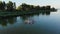 Aero. group of women practicing SUP yoga, they balancing on paddle boards, on water of large river, during summer warm