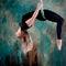 Aero yoga, a young woman doing yoga or stretching on a suspension,