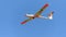 Aerobatic glider on blue sky, withe wings sport team