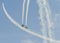 Aerobatic pilots with her colored airplanes training in the blue sky