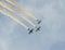 Aerobatic pilots training in the blue sky, airplanes with colored trace smoke