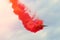 Aerobatic team aircraft fighters trail of red smoke in the sky.