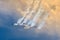 Aerobatic team aircraft fighters trail of smoke in the sky.