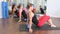Aerobics pilates women personal trainer with pupil in a row at gym