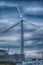 The aerogenerator windmill against cloudy sky