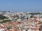 An aeroplane above red roofs buildings of lisbon city portugal