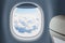 Aeroplane or jet window with clouds behind, traveling concept.