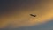 Aeroplane silhouette on a vivid morning sunrise sky space for text clouds.