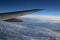 Aeroplane wing, blue sky, broken white cloud