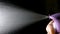 Aerosol can being sprayed against a black background, in slow motion