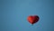 Aerostat heart in the blue sky
