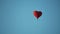 Aerostat heart in the blue sky