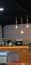 Aesthetic cafe counter with hanging light bulbs