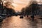 Aesthetic canals of Amsterdam at sunset, view from the water, houseboats on the canal, houseboats hotels. Romantic canal boat ride