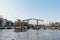 Aesthetic canals of Amsterdam at sunset, view from the water, view of the modern drawbridge,Netherlands, Amsterdam 12.04.2023