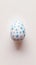Aesthetic easter egg in traditional blue ethnic painting style. White background. Copy space. Generative AI
