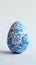 Aesthetic easter egg in traditional blue ethnic painting style. White background. Copy space. Generative AI