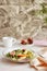 Aesthetic fresh salad of potato, arugula, grain cheese, peach and figs. Mediterranean healthy dish, vegan salad, easy