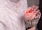Aesthetic rose in the hands of a girl.Romantic image. White knit sweater and delicate rose
