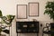 Aesthetics composition of living room interior with mock up poster frame, stylish sideboard, beige bowl, black sculpture, plants