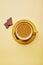 Aesthetics spring coffee with chocolate on yellow background top view with copy space