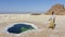 Afar soldier near a salty pond in the plain of salt in the Danakil Depression in Ethiopia in Africa.