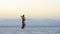 Afar soldier walking during sunset on the salt plains of Asale Lake in the Danakil Depression in Ethiopia, Africa