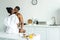 affectionate african american couple kissing on kitchen counter