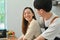 Affectionate asian man and smiling woman preparing homemade pastry, spending time in cozy modern kitchen at home