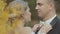 Affectionate bride corrects bow tie groom and they