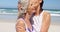 Affectionate daughter kissing her mother at beach