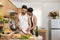 Affectionate gay couple enjoy cooking at kitchen together