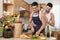 Affectionate gay couple enjoy cooking at kitchen together