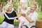 Affectionate Granddaughter and Grandparents Playing At The Park