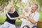 Affectionate Granddaughter and Grandparents Playing At The Park