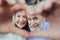 Affectionate happy old senior couple grandparents make heart shape hand gesture. Look at camera bonding laughing showing family