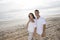 Affectionate Hispanic couple standing on beach