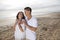 Affectionate Hispanic couple standing on beach