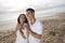 Affectionate Hispanic couple standing on beach